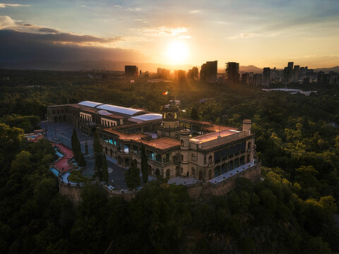 Aerial drone view of Castillo de Chapultepec, Bosque de Chapultepec park and city skyline in Mexico City at sunset, Mexico.