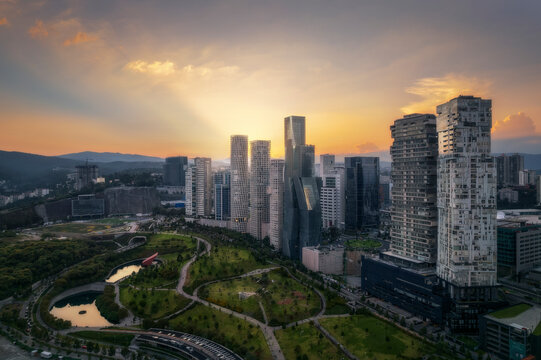 Aerial drone view of La Mexicana park in Santa Fe, a financial district in Mexico City, with skyscrapers at sunset, Mexico.