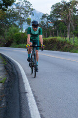 lifestyle concept. cyclist on the road training. general plan. green
