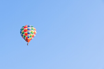 Hot air balloons landing in a mountain flight over field and forest,colorful Hot air balloons flying over the valley with blue sky,Tourism concept.