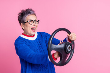 Photo of positive crazy funny woman wear trendy clothes hold steering wheel drive fast empty space...
