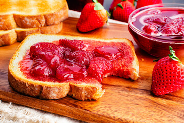 Slice of Toast and Homemade Strawberry Preserves and Missing a Bite: Bitten piece of toasted white...