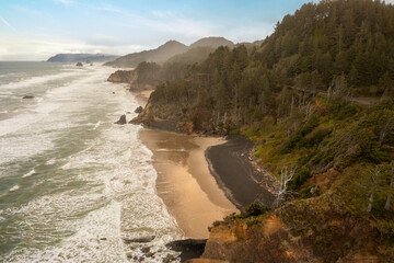 Aerial drone view of Arch Cape, Oregon. Arch Cape State Park features a beautiful beach and shoreline, two small lagoons, and a spectacular view of the ocean from the Arch Cape headland.