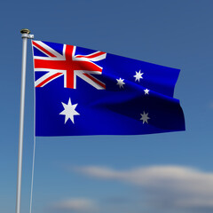 Australia Flag is waving in front of a blue sky with blurred clouds in the background
