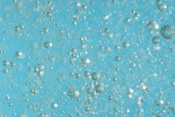Bubbles in the water on a blue background. Closeup.