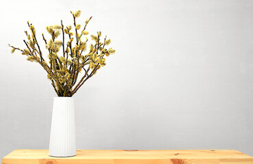 Beautiful spring flower arrangement.Empty podium for product with fresh willow flowers,elegant beauty concept.Stage for product display and business concept.Minimal modern aesthetic.