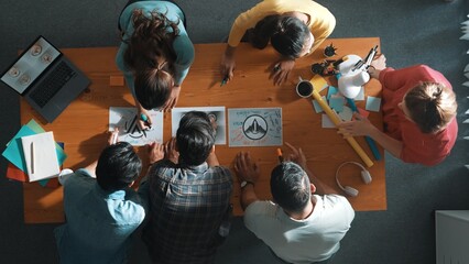 Top view of business team put graphic logo on meeting table with laptop and paper and start to...