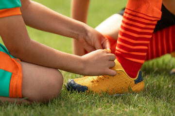 Soccer Boy Helping Teammate to Tie Laces. Friends in Sports Team. Kids Play Football Game Wearing...
