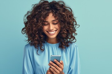 A happy woman in blue blouse using her smartphone on light blue background, space for text 