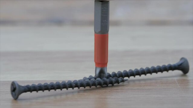 A phillips screwdriver, a bit, rotates and moves the roofing screws. worm gear