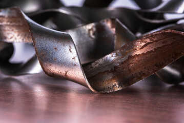 Abstract steel curves and waves on metal surface with soft toned background