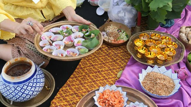 Making Miang Kham (traditional Southeast Asian herbal snack from Thailand and Laos), Traditional Thai snack. It&rsquo;s a snack containing different ingredients of herbs and vegetables. 
