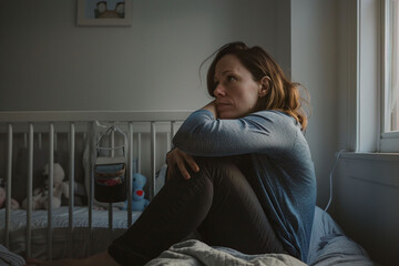 Contemplative mother in nursery, postpartum depression awareness. Design for health poster, psychological support