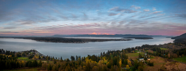 Sunset panorama of Hale Passage with Mt. Baker and the Sisters mountains in the Background. Seen from Lummi Island located in the Salish Sea area of western Washington state.