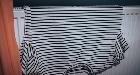 striped T-shirt, dried on a radiator