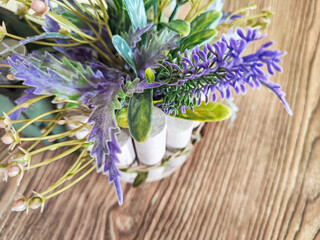 Colorful bouquet of gentle spring flowers placed on a rustic wooden table. Background, place for text, copy space