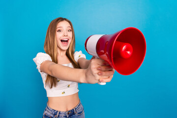 Photo of nice young girl loudspeaker empty space wear top isolated on blue color background - obrazy, fototapety, plakaty