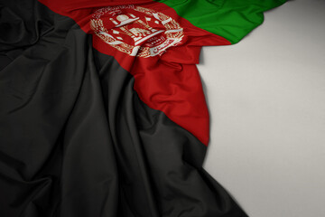 waving national flag of afghanistan on a gray background.