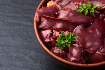 Raw chicken giblets liver, meat background.