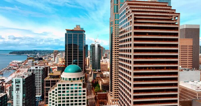 Drone flying between the high-rise buildings in the downtown of Seattle, WA, United States. Beautiful cityscape of metropolis at day.