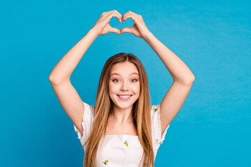 Photo of happy positive girl show heart shape symbol isolated blue color background