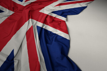 waving national flag of great britain on a gray background.