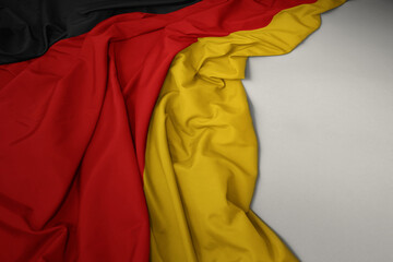 waving national flag of germany on a gray background.