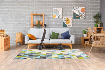 Interior of modern living room with electric scooter and sofa