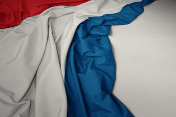 waving national flag of luxembourg on a gray background.