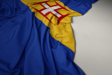 waving national flag of madeira on a gray background.