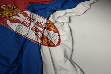 waving national flag of serbia on a gray background.