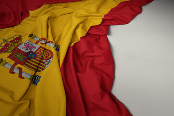 waving national flag of spain on a gray background.