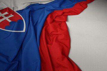 waving national flag of slovakia on a gray background.