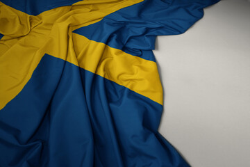 waving national flag of sweden on a gray background.