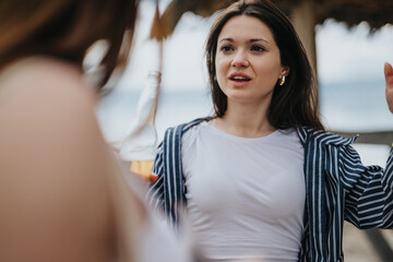 A young woman tourist engages in a friendly chat while savoring her holiday at a beach side location, embodying the essence of travel and leisure.