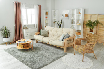 Interior of cozy living room with sofa, table and drawers