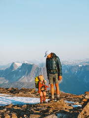 Father and daughter child on mountain top in Norway climbing together, family adventure hobby...