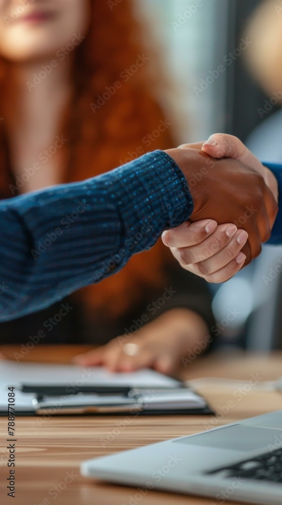 Poster two people shaking hands at a table with laptops on it. generative ai.