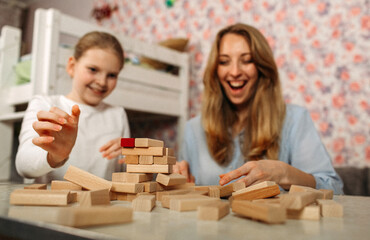 Woman and Child Playing With Wooden Blocks