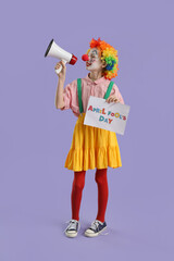 Funny little girl dressed as clown with card shouting into megaphone on lilac background. April Fools' Day celebration