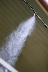 Fogger machine closeup. Automatic mist nozzle water spraying system to make humidifier and cooling...