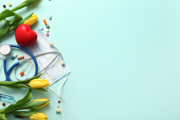 Mask with stethoscope, yellow tulips and pills for International Nurses Day on turquoise background