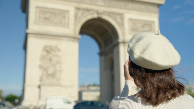 Woman Photographing Triumphal Arch with Smartphone