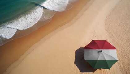 An aerial vista of a sandy beach with gentle ocean waves, featuring a beach umbrella adorned with the Hungary flag. Ideal for Hungary tourists seeking seaside relaxation