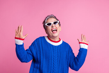 Photo of nice aged lady dancing have fun wear blue sweater isolated on pink color background