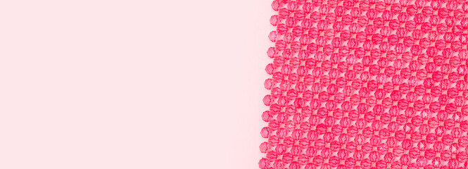 Banner with detail for handcraft bag made from square beads on a pink background.