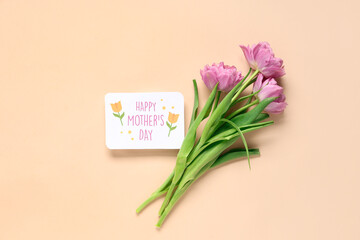 Greeting card with text HAPPY MOTHER'S DAY and beautiful lilac tulips on beige background