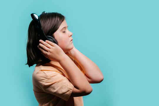Young girl enjoying music with headphones