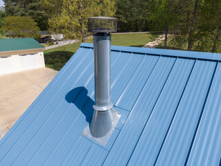 New steel metal light blue roof on a single family home featuring 5V style panels. 