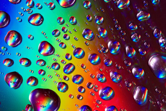 Colorful raindrops on a CD surface reflecting light